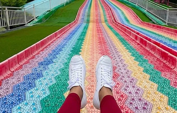 Colorful rainbow slide at Bali glass bridge adventure park